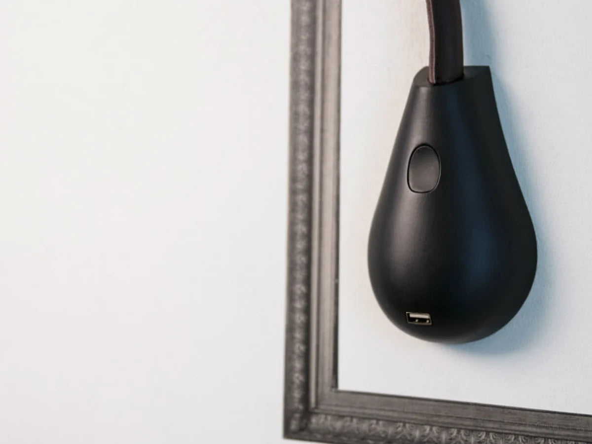 Elegant brown leather Innermost Cobra lamp with dimmable LED and convenient USB charging station.