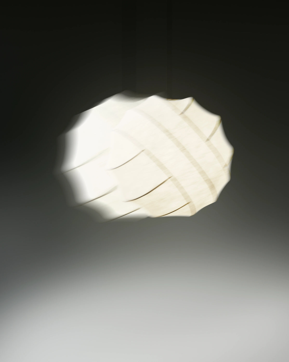 Pholc Turner cocoon pendant light by Broberg & Ridderstråle – Turner 80 glowing against a dark backdrop