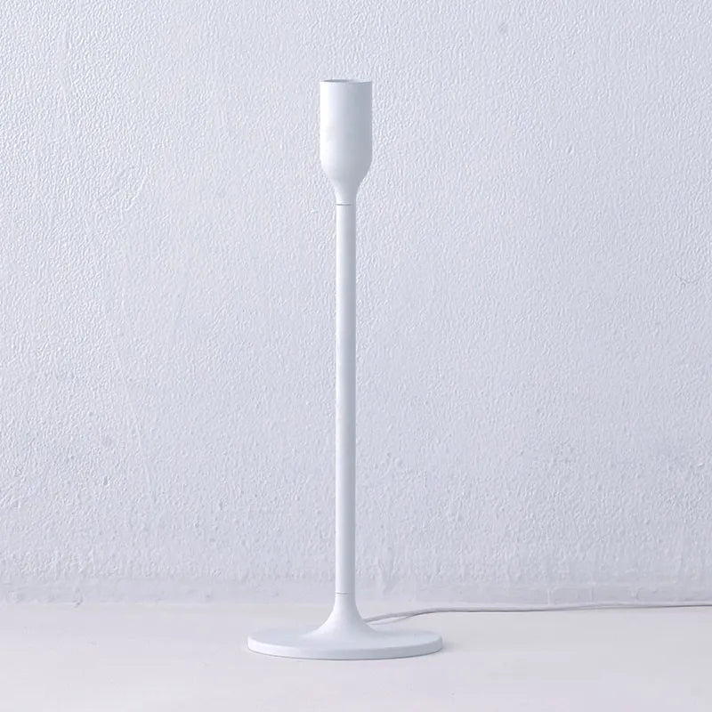 Close-up of the minimalist Innermost Yoy LED desk lamp, showcasing its unique light projection effect.