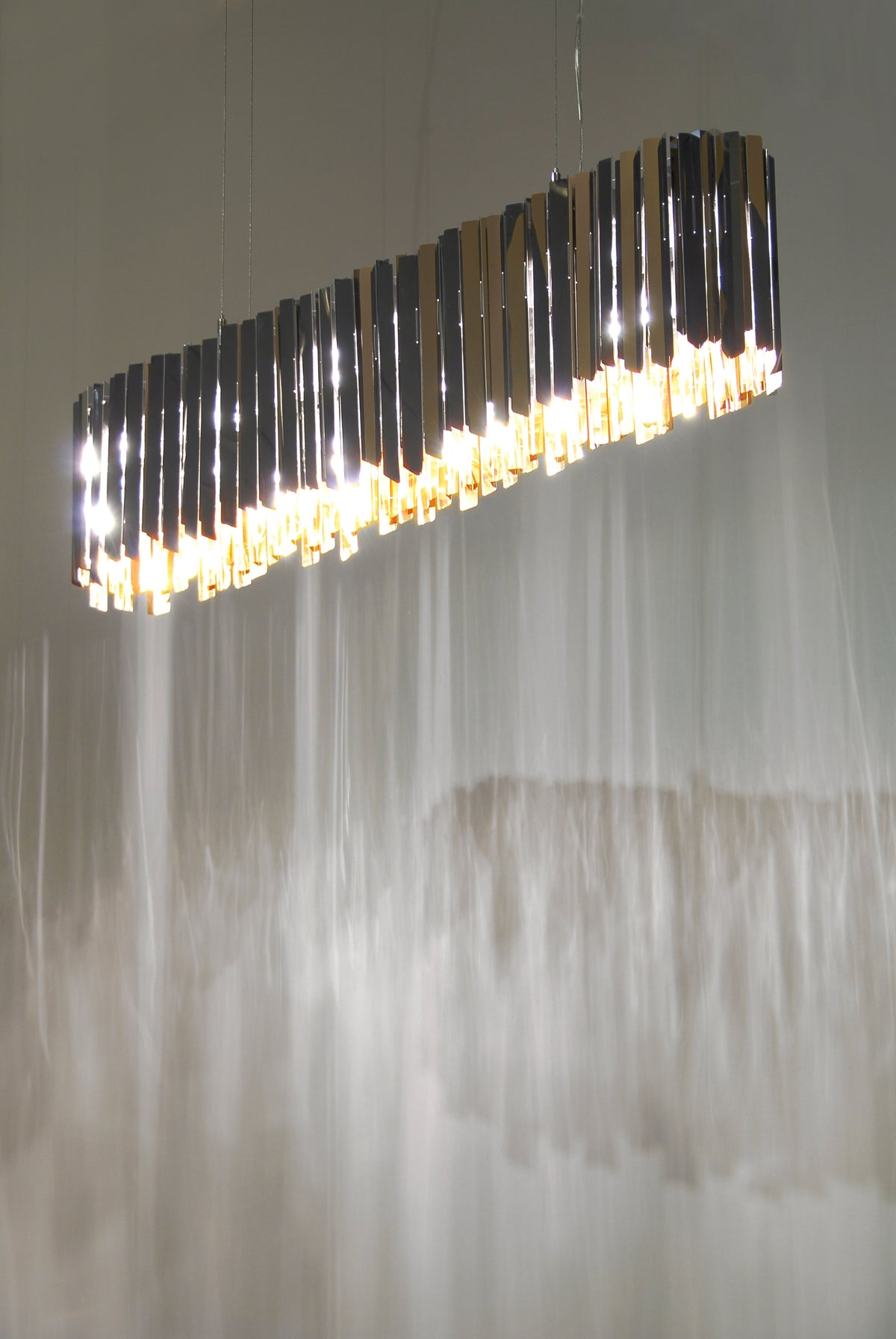 Innermost Facet Lozenge linear chandelier by Tom Kirk – the Facet family