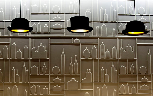 Innermost Wooster pendant light by Jake Phipps – a row of hats along a wall