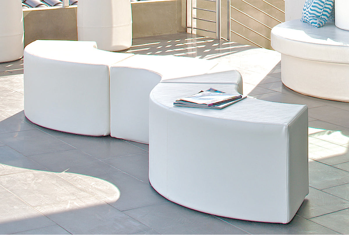 White Arc and rectangular benches arranged on a patio terrace with a magazine on top