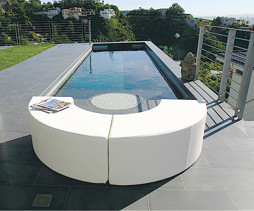 Two white Arc modules forming a half circle beside a long pool