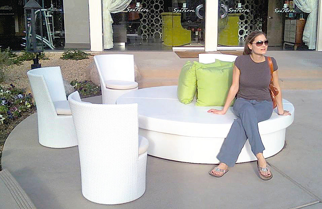 Guest seated on a round white Sun Pad beside white modular chairs in a resort lounge