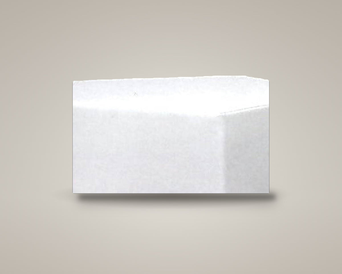 Z-Dot five-sided pentagon ottoman in white vinyl on a soft warm-grey studio backdrop with a floor shadow, angled view