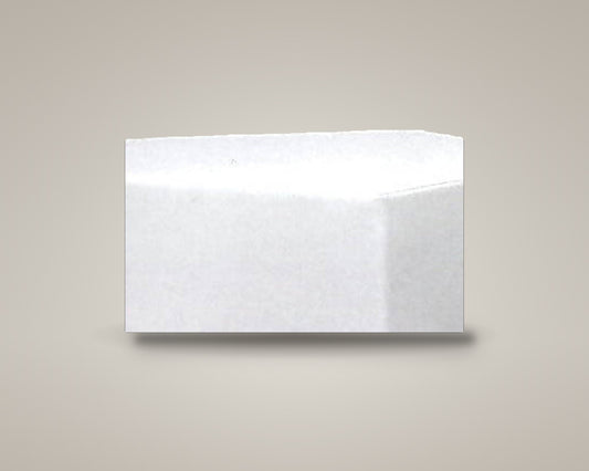 Z-Dot five-sided pentagon ottoman in white vinyl on a soft warm-grey studio backdrop with a floor shadow, angled view