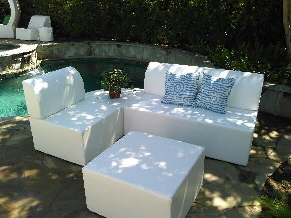 Zinc 30-inch square ottoman in white marine vinyl used as a low table in front of a Zig Duo bench and Zig chair, poolside
