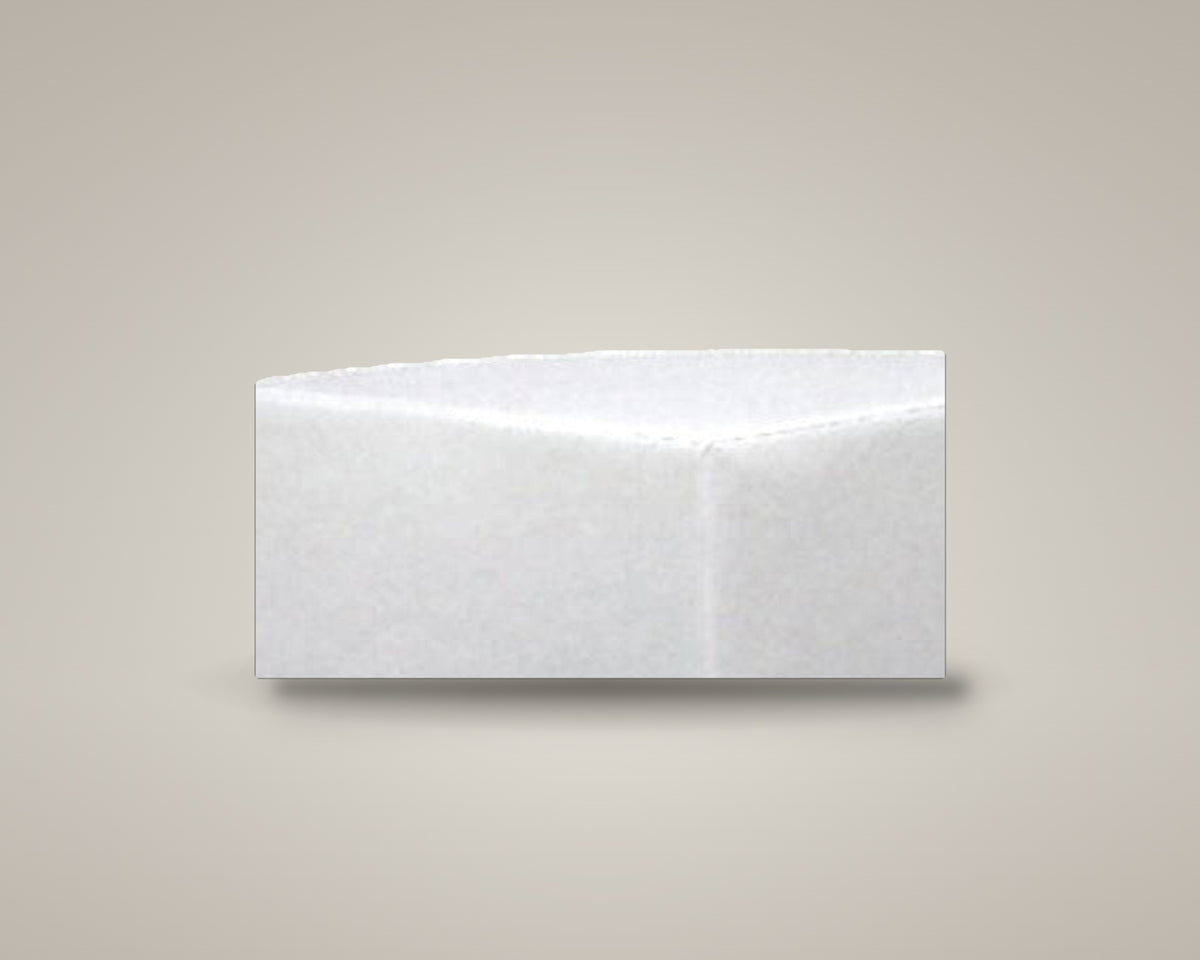 Zest corner ottoman in white vinyl on a soft warm-grey studio backdrop with a floor shadow, angled view