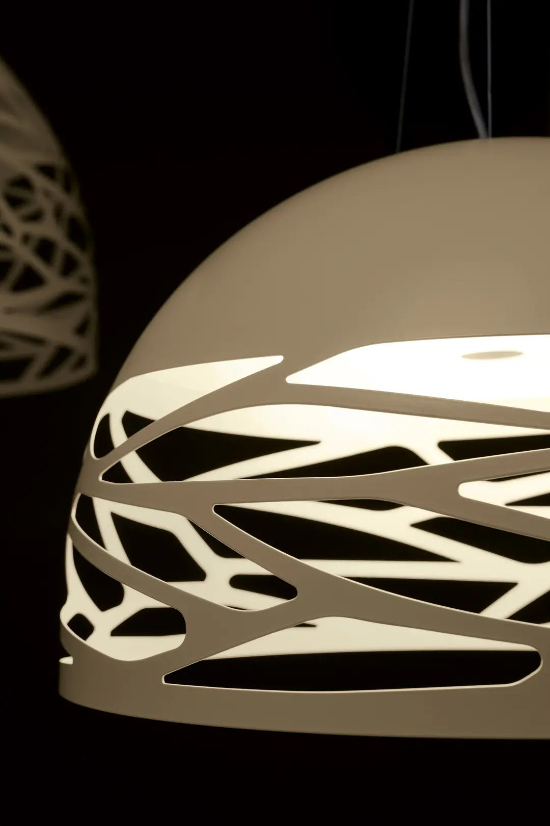 Lodes Kelly Dome Chamagne pendant light suspended above a modern dining table