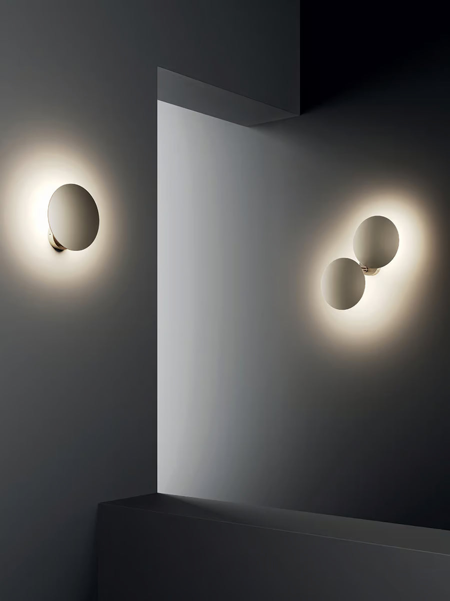 Minimalist round LED wall light by Lodes in matte champagne finish for contemporary living rooms, bedrooms, and hallways