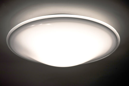Besa Luma 18 lit against a dark ceiling, showing the clear halo edge