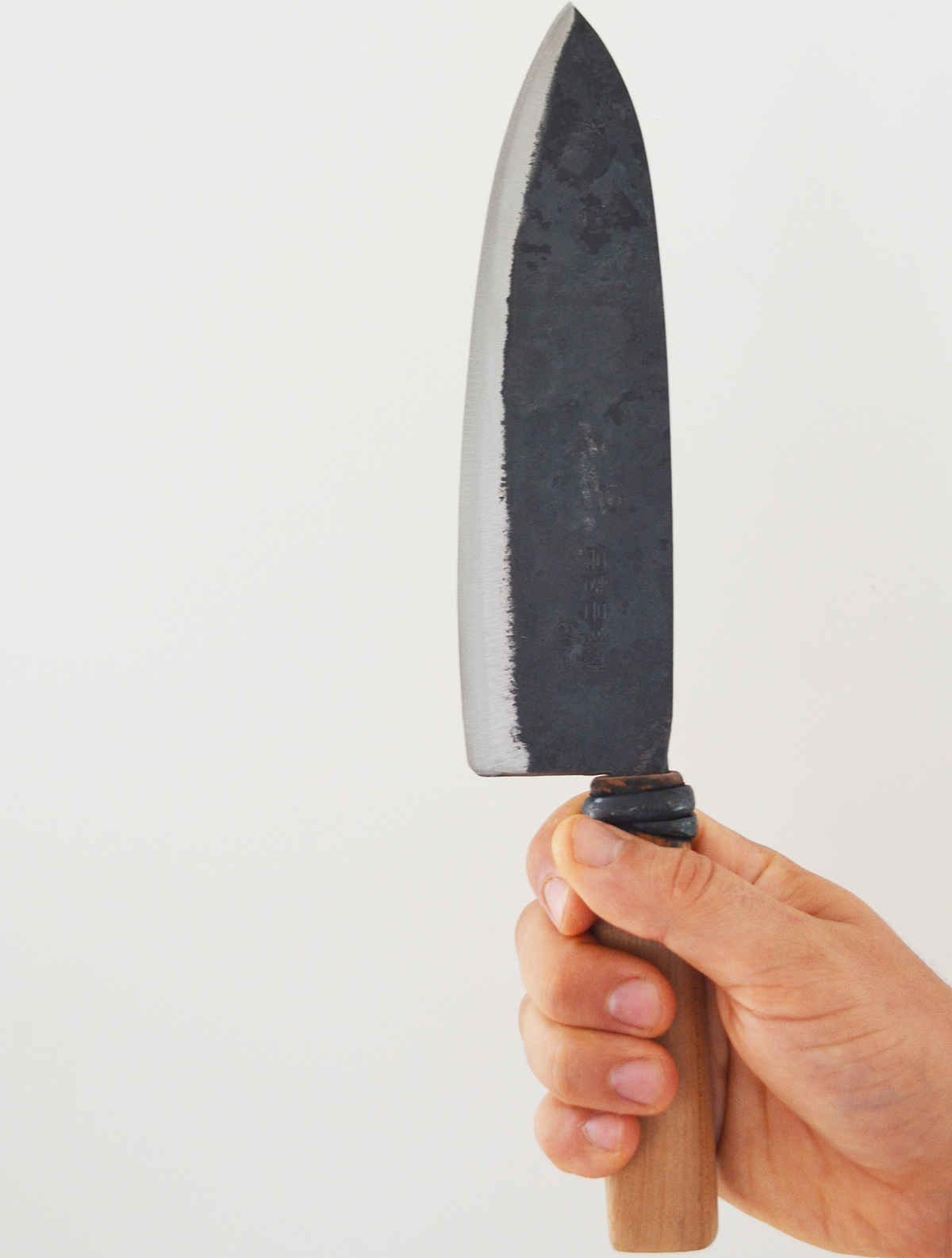 Hand holding the #62 medium kitchen knife upright