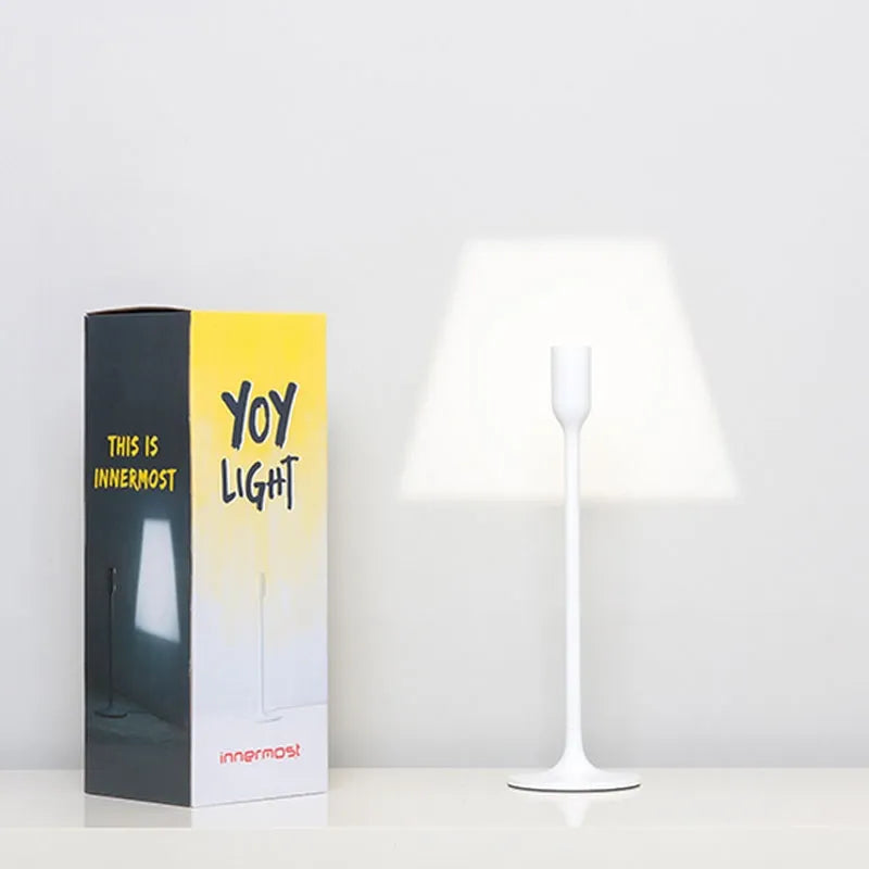 Modern Innermost Yoy LED projection lamp, adding an artistic light illusion to a contemporary hotel suite.