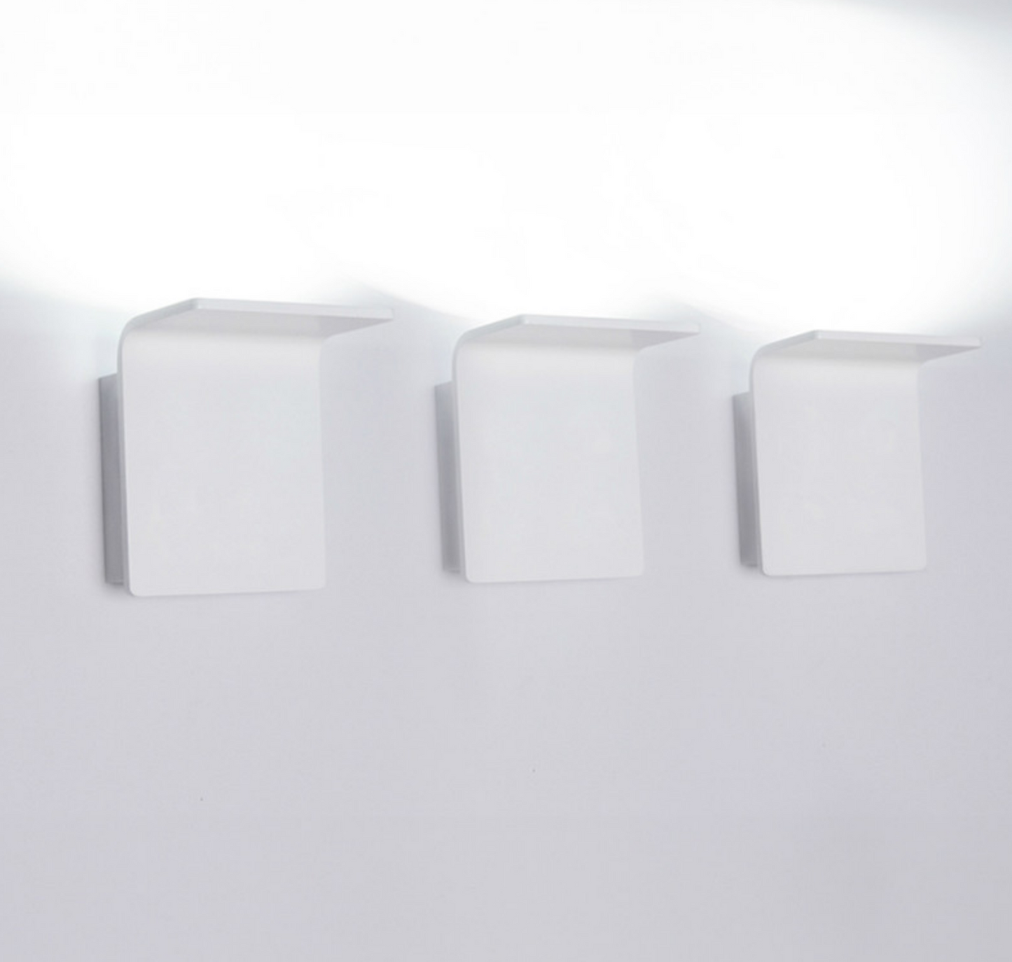 Modern white LED uplight/downlight fixture, Innermost Bracket series WB0883-01, perfect for illuminating hallways, bedrooms, or contemporary entryways.