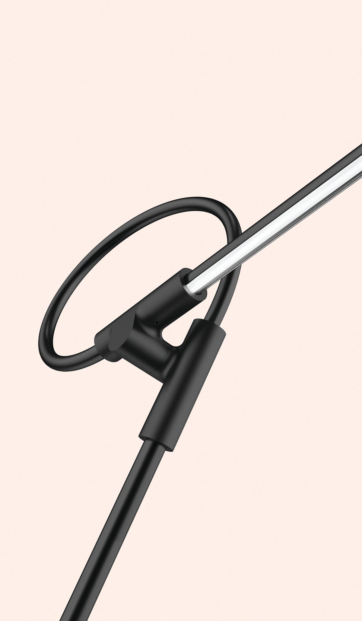 Pablo Designs Superlight table lamp in Black, sweeping arm against a blush wall