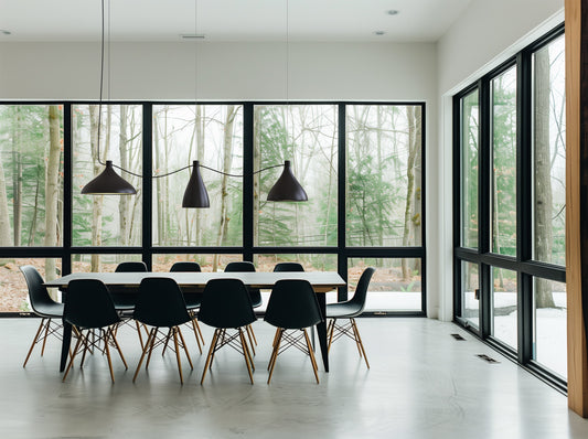 Pablo Designs Swell pendants in black over a long dining table