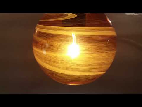 Modern outdoor pendant light with Vapor Amber glass shade and warm illumination