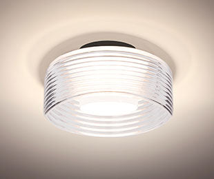 Besa Belu Clear ribbed drum lit, inner white shield glowing through the ribs