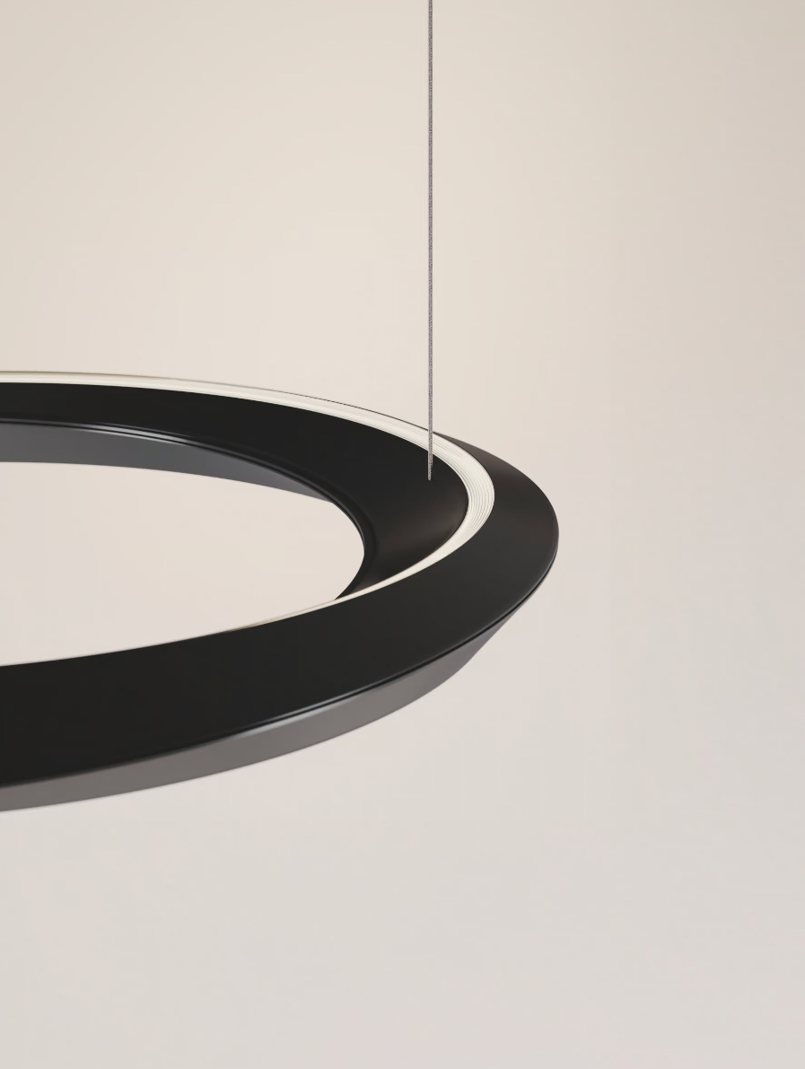 Matte Black Lodes Tidal LED chandelier suspended above a modern dining table