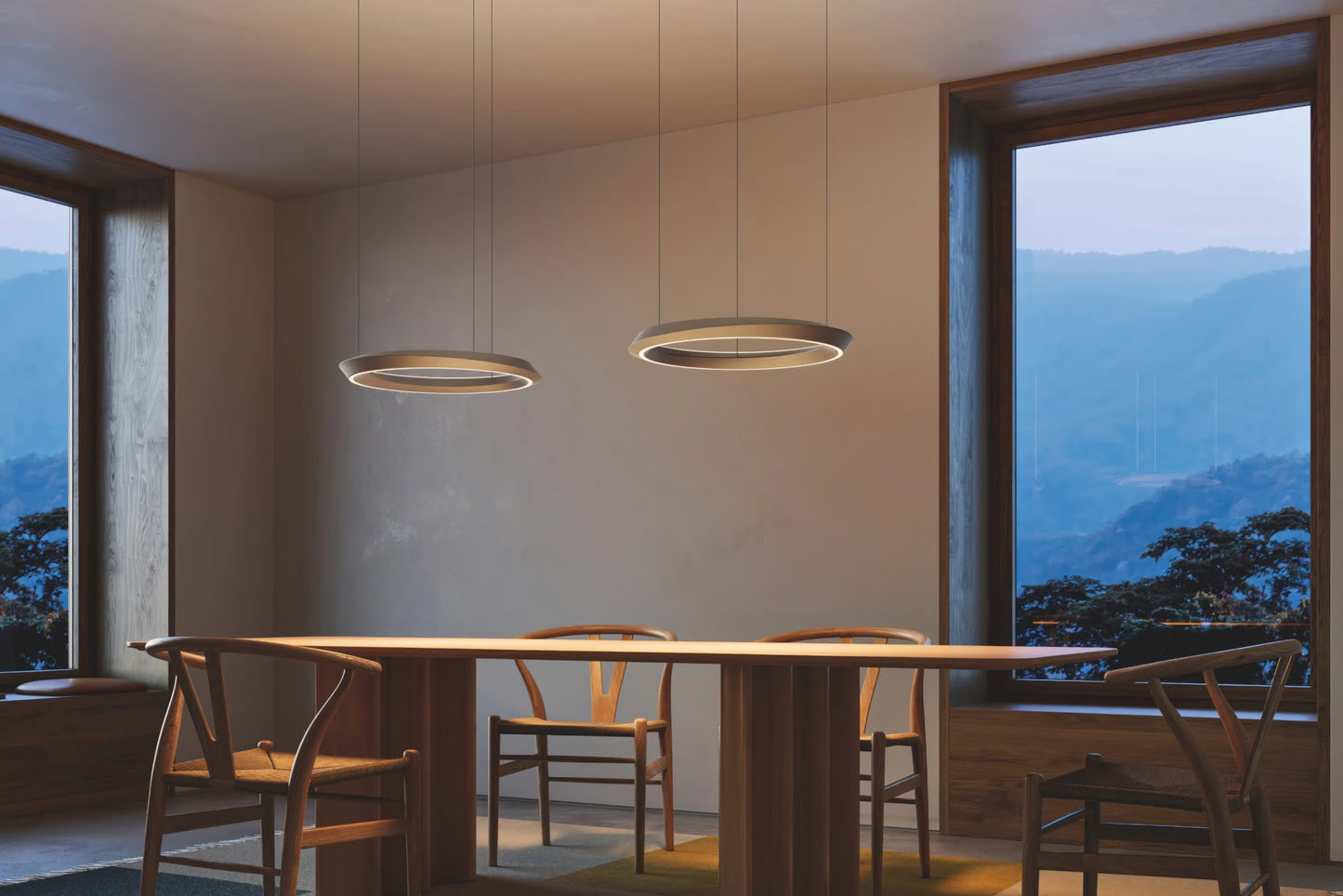 Matte Champagne Lodes Tidal LED pendant light installed in a contemporary dining room