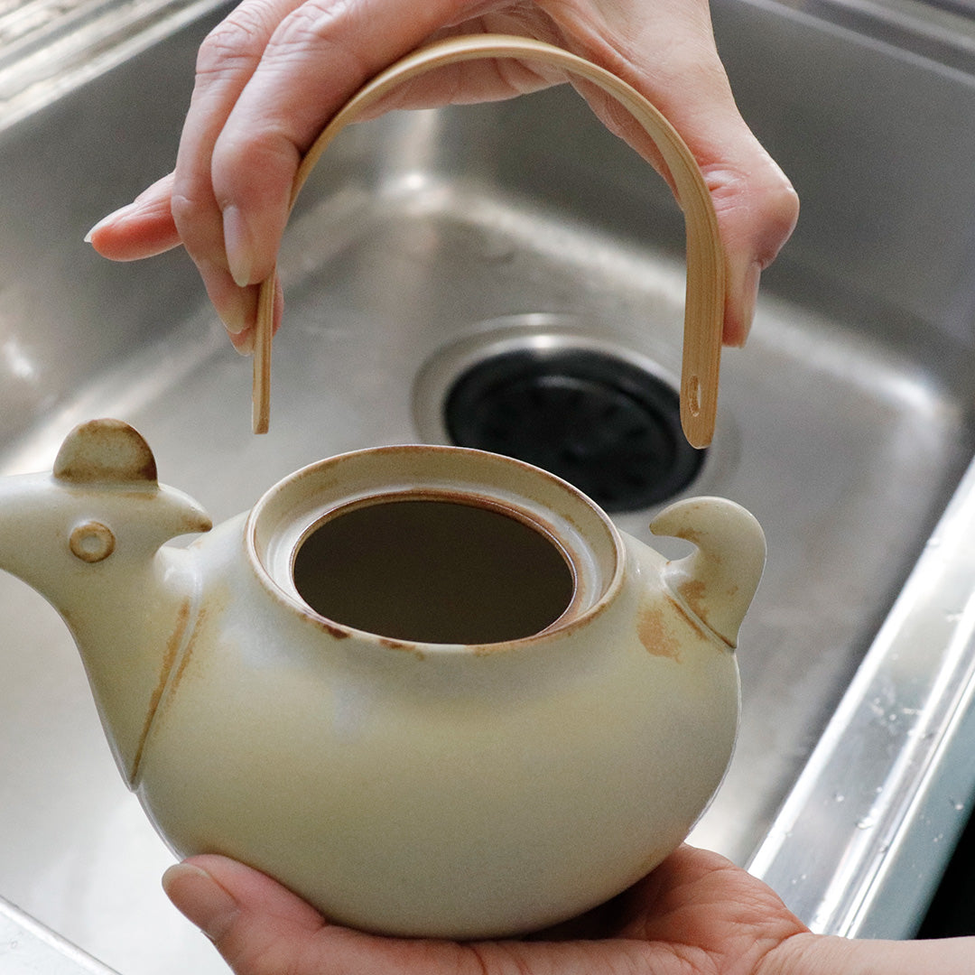 Ceramic Japan Tori Bird Teapot – held in two hands, lid off