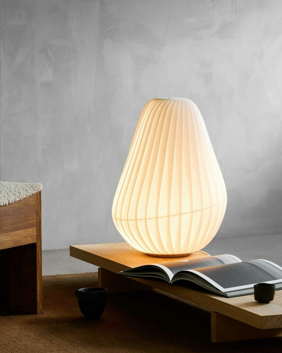 Tom Rossau TR31 table lamp – lit on a side table