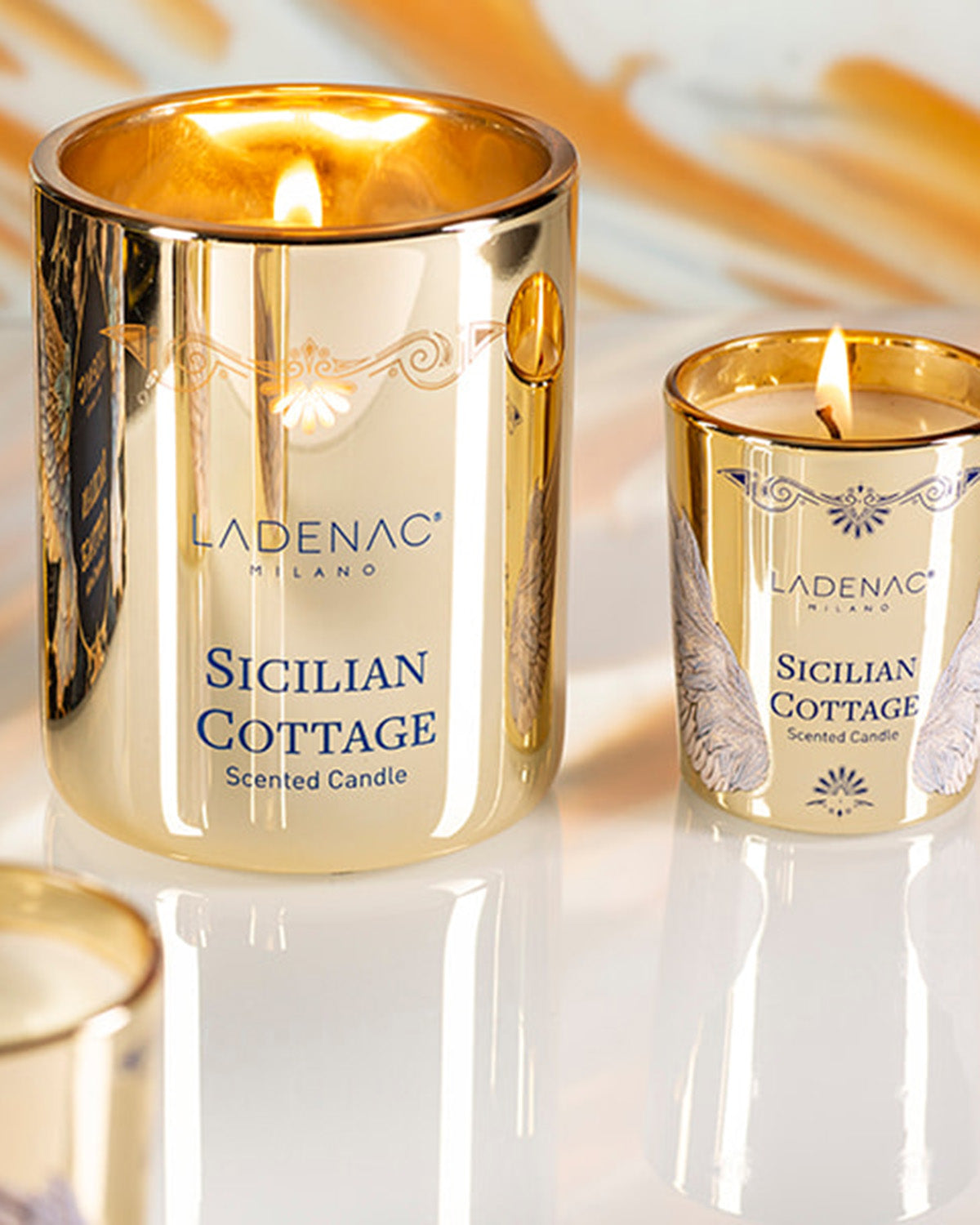 Sicilian Cottage 330 g scented candle by Ladenac Milano, lit candle in its gold jar