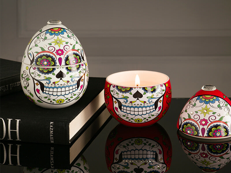 Ladenac Milano Skull ceramic candle 220 g, White skulls styled together with a lit candle