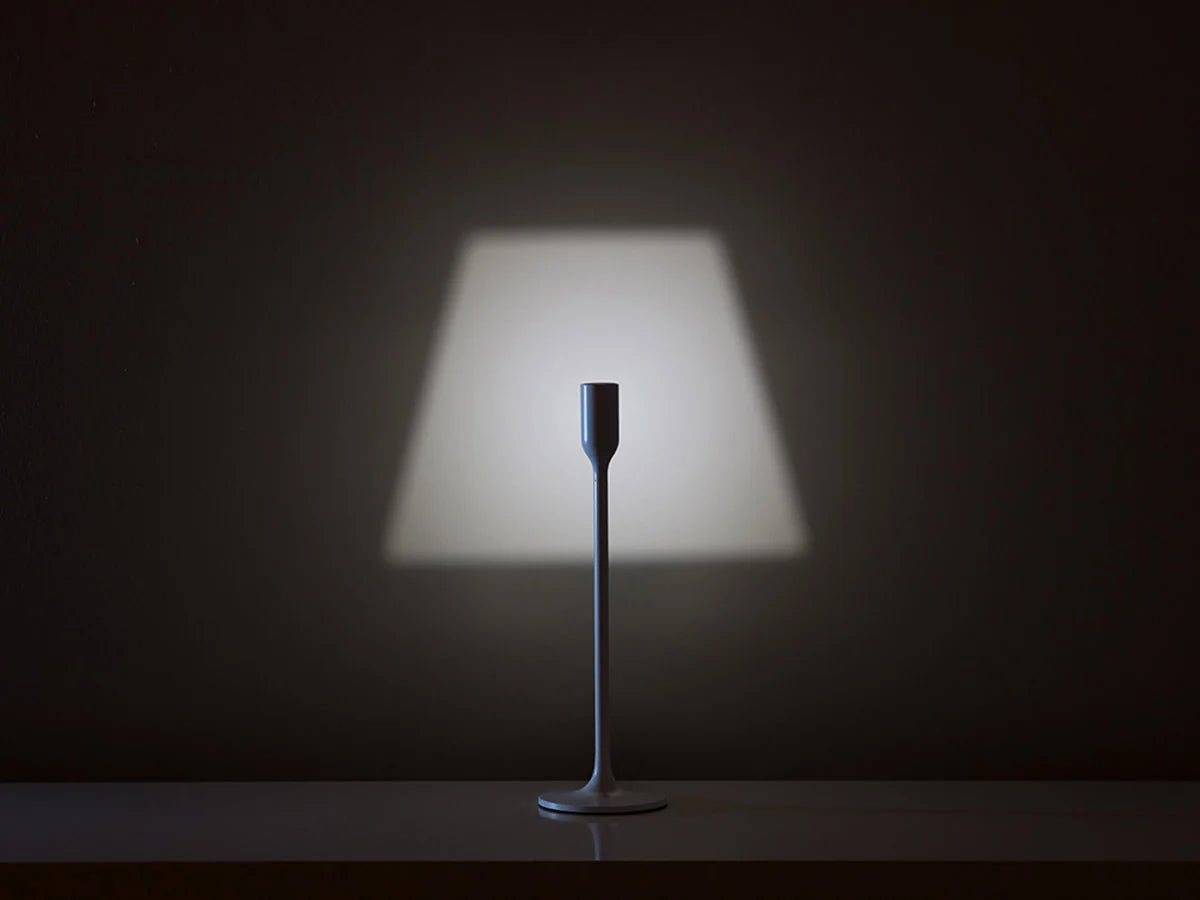 Yoy Table Lamp by Innermost on a minimalist study desk, providing clever functional lighting with a decorative projected shade.