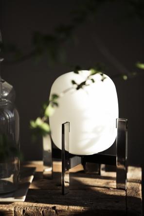 Discover the Santa & Cole Cestita Metalica Table Lamp featuring a stainless steel frame, opal glass shade, and soft ambient lighting for modern interiors
